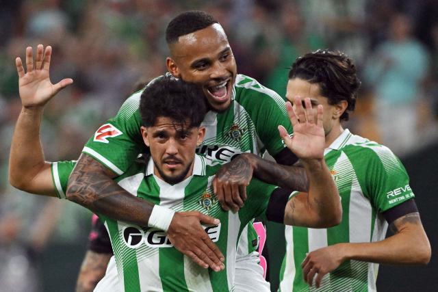 Real Betis' Spanish midfielder #08 Pablo Fornals (BOTTOM) celebrates scoring his team's second goal with Real Betis' Brazilian defender #04 Natan Bernardo de Souza during the Spanish league football match between Real Betis and Malaga CF at La Cartuja stadium in Seville on October 31, 2026. (Photo by JORGE GUERRERO / AFP)