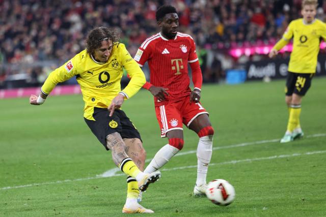 Dortmund's Portuguese forward #21 Fabio Silva (L) scores the 2-2 goal next to Bayern Munich's Canadian defender #19 Alphonso Davies during the German first division Bundesliga football match between FC Bayern Munich and BVB Borussia Dortmund in Munich, southern Germany, on October 31, 2026. (Photo by Alexandra BEIER / AFP) / DFL REGULATIONS PROHIBIT ANY USE OF PHOTOGRAPHS AS IMAGE SEQUENCES AND/OR QUASI-VIDEO