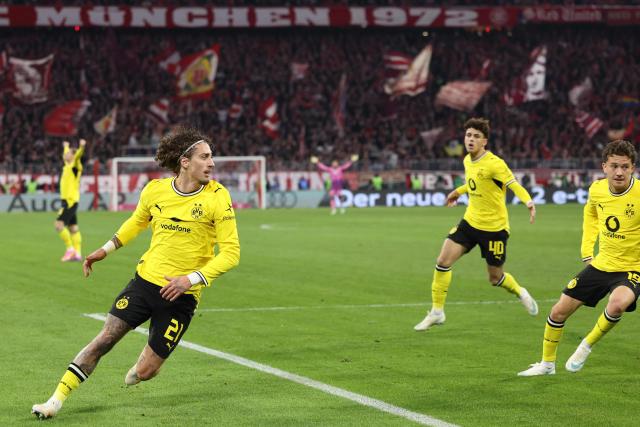 Dortmund's Portuguese forward #21 Fabio Silva (L) celebrates scoring the 2-2 goal with his teammates during the German first division Bundesliga football match between FC Bayern Munich and BVB Borussia Dortmund in Munich, southern Germany, on October 31, 2026. (Photo by Alexandra BEIER / AFP) / DFL REGULATIONS PROHIBIT ANY USE OF PHOTOGRAPHS AS IMAGE SEQUENCES AND/OR QUASI-VIDEO
