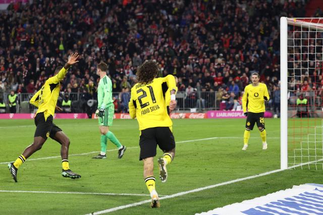 Dortmund's Portuguese forward #21 Fabio Silva celebrates scoring the 2-2 goal with his teammates during the German first division Bundesliga football match between FC Bayern Munich and BVB Borussia Dortmund in Munich, southern Germany, on October 31, 2026. (Photo by Alexandra BEIER / AFP) / DFL REGULATIONS PROHIBIT ANY USE OF PHOTOGRAPHS AS IMAGE SEQUENCES AND/OR QUASI-VIDEO