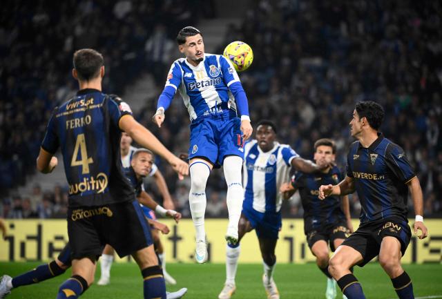 FC Porto's Spanish forward #17 Borja Sainz jumps for the ball during the Portuguese League football match between FC Porto and GD Estoril Praia at Dragao stadium in Porto on October 31, 2026. (Photo by Miguel RIOPA / AFP)