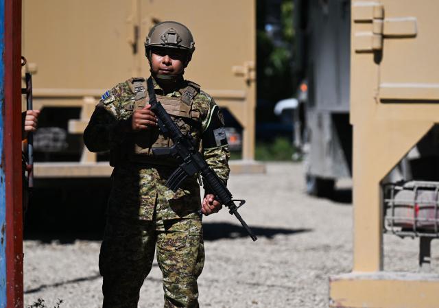 A Salvadoran Army soldier stands guard at their encampment in the Tabarre neighborhood after their arrival in Port-au-Prince,Haiti, on October 31,2026. Over 2,000 troops have flown in from El Salvador to Haiti in little over a week, effectively doubling the contingent of foreign soldiers operating in the Caribbean island nation. President Nayib Bukele ordered the rapid deployment after four Salvadoran personnel, who were operating in Haiti as part of a UN-backed anti-gang force, went missing in an ambush attack on October 18. (Photo by Clarens SIFFROY / AFP)