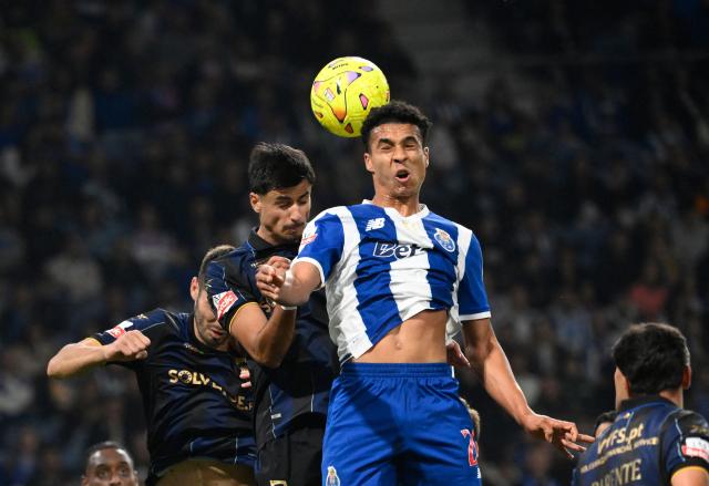 FC Porto's Portuguese defender #20 Alberto Costa (R) jumps for the ball during the Portuguese League football match between FC Porto and GD Estoril Praia at Dragao stadium in Porto on October 31, 2026. (Photo by Miguel RIOPA / AFP)