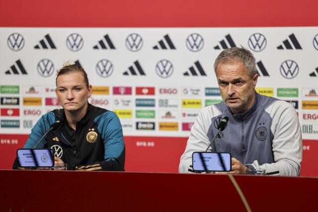 27 October 2024, North Rhine-Westphalia, Duisburg: Germany women's coach Christian Wueck (R) and player Alexandra Popp attend a press conference ahead of the Women's international soccer match against Australia. Photo: Christoph Reichwein/dpa