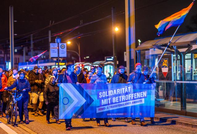 04 November 2024, Mecklenburg-Western Pomerania, Rostock: Demonstrators march through Rostock city center to protest against the suspected arson attack on a queer bar. According to the police, around 1,500 people took part in the event. Photo: Jens Büttner/dpa