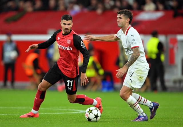 FILED - 01 October 2024, North Rhine-Westphalia, Leverkusen: Leverkusen's Martin Terrier (L) and Milan's Christian Pulisic fight for the ball during the UEFA Champions league soccer match between Bayer Leverkusen and AC Milan at BayArena. Terrier has joined Bayer Leverkusen's long list of injured players ahead of their Champions League match against Red Bull Salzburg on 26 November. Photo: Federico Gambarini/dpa