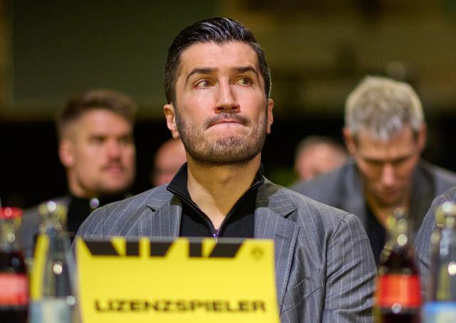 24 November 2024, North Rhine-Westphalia, Dortmund: Borussia Dortmund Coach Nuri Sahin sits in the audience during the general meeting. Photo: Bernd Thissen/dpa