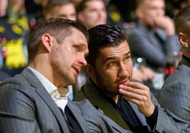 24 November 2024, North Rhine-Westphalia, Dortmund: Borussia Dortmund Coach Nuri Sahin (R) talks to sports director Sebastian Kehl in the audience. during the general meeting. Photo: Bernd Thissen/dpa