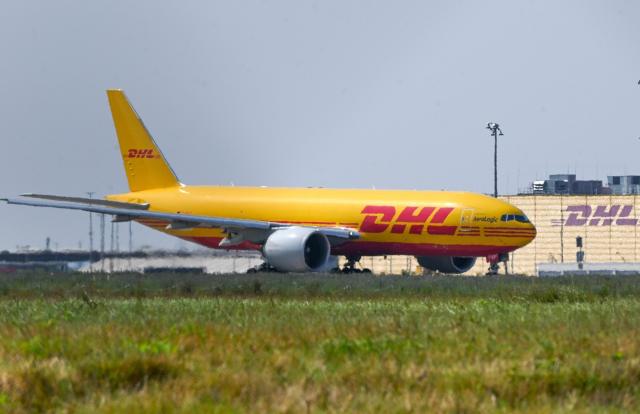 FILED - 30 August 2024, Saxony, Schkeuditz: A DHL aircraft stands in front of the DHL Air Hub at Leipzig / Halle Airport.  An aircraft flying from Leipzig on behalf of the DHL logistics firm crashed into a residential building near the Vilnius airport, killing at least one person and wounding three, the BNS news agency reported, citing an emergency services spokeswoman. Photo: Heiko Rebsch/dpa