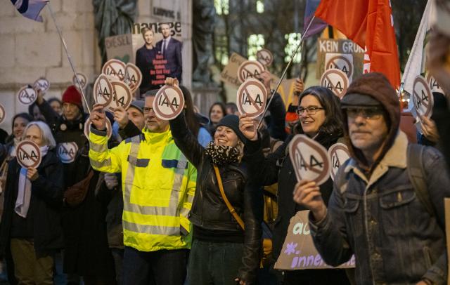 26 November 2024, Bavaria, Munich: Demonstrators take part in a rally organized by the Munich Nature Conservation Association against further IAAs exhibition. The Munich City Council will decide on Wednesday whether to host further exhibitions in the city center. Photo: Lukas Barth/dpa