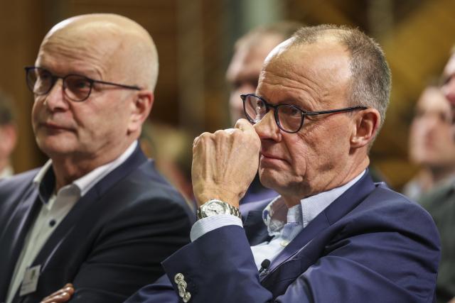 12 December 2024, North Rhine-Westphalia, Olsberg: Christian Democratic Union of Germany (CDU) federal chairman and candidate for chancellor Friedrich Merz (R) and President of the Westphalian-Lippish Agricultural Association Hubertus Beringmeier listen to a speaker at the Westphalian-Lippish Agricultural Association (WLV). Photo: Christoph Reichwein/dpa