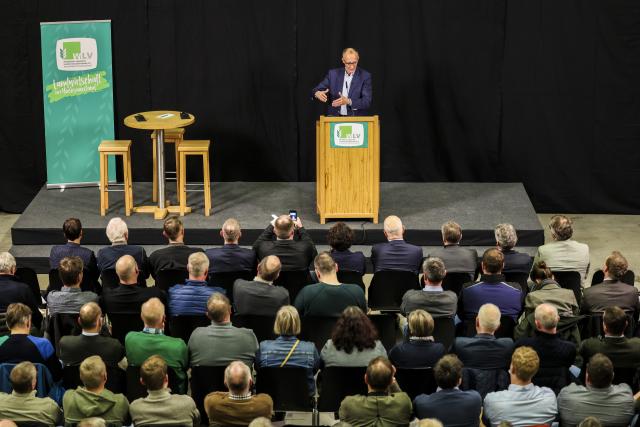 12 December 2024, North Rhine-Westphalia, Olsberg: Christian Democratic Union of Germany (CDU) federal chairman and candidate for chancellor Friedrich Merz speaks at the Westphalian-Lippe Agricultural Association (WLV) on the topic of "Future policy in rural areas". Photo: Christoph Reichwein/dpa