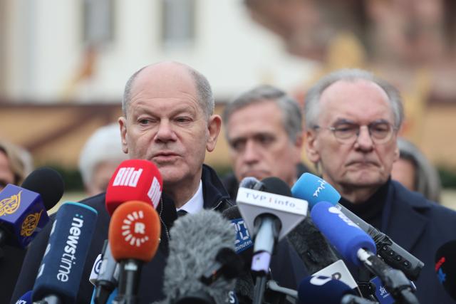 21 December 2024, Saxony-Anhalt, Magdeburg: Germany's Chancellor Olaf Scholz (L) delivers a statement alongside Reiner Haseloff, Minister President of Saxony-Anhalt, following their visit to the scene of the fatal attack at Magdeburg's Christmas market. The previous evening, a car driver struck a group of people at the market, causing multiple fatalities and injuries. Photo: Matthias Bein/dpa