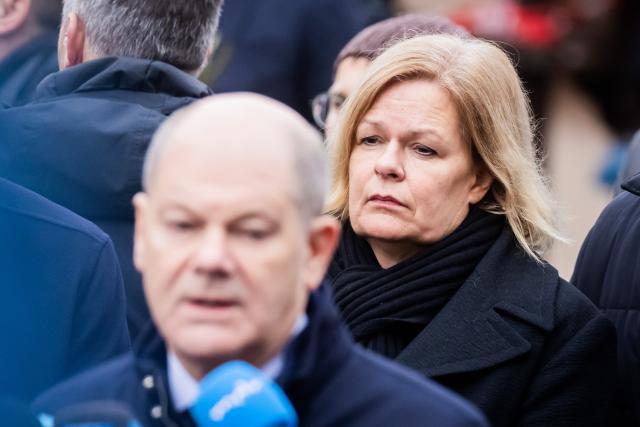 21 December 2024, Saxony-Anhalt, Magdeburg: Nancy Faeser, Germany's Minister of the Interior and Home Affairs, stands beside Chancellor Olaf Scholz at the Christmas market in Magdeburg as he makes a statement. The previous evening, a driver drove into a group of people at the market, resulting in fatalities and injuries. Photo: Christoph Soeder/dpa