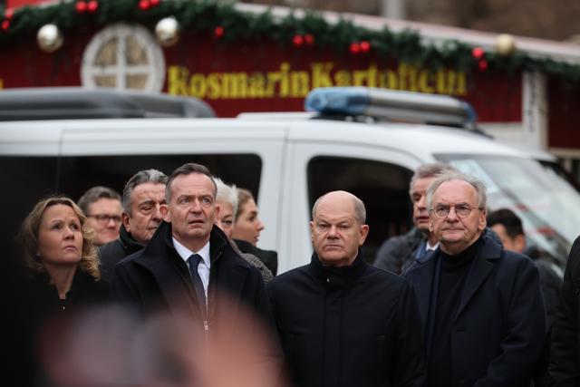 21 December 2024, Saxony-Anhalt, Magdeburg: (L-R) Nancy Faeser, Germany's Minister of the Interior and Home Affairs, Reiner Haseloff, Minister-President of Saxony-Anhalt, Volker Wissing, Germany's Minister for Digital Affairs and Transport, and Federal Chancellor Olaf Scholz (SPD) visit the scene of the fatal attack at the Christmas market in Magdeburg. The previous evening, a car driver drove into a group of people at the market, killing and injuring several individuals. Photo: Jan Woitas/dpa