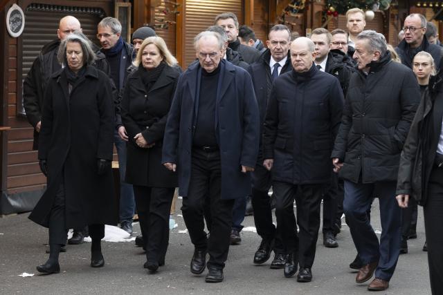 21 December 2024, Saxony-Anhalt, Magdeburg: (L-R) Nancy Faeser, Germany's Minister of the Interior and Home Affairs, Reiner Haseloff, Minister-President of Saxony-Anhalt, Volker Wissing, Germany's Minister for Digital Affairs and Transport, and Federal Chancellor Olaf Scholz (SPD) visit the scene of the fatal attack at the Christmas market in Magdeburg. The previous evening, a car driver drove into a group of people at the market, killing and injuring several individuals. Photo: Sebastian Kahnert/dpa