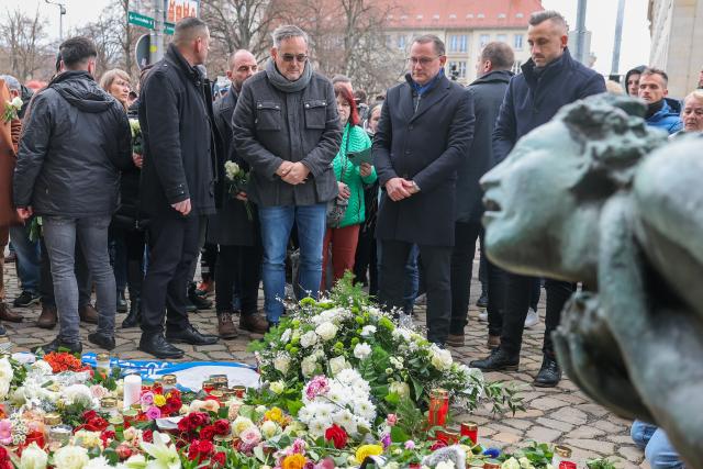 21 December 2024, Saxony-Anhalt, Magdeburg: Tino Chrupalla (2nd R), Chairman of the Alternative for Germany (AfD) party, lays flowers at the official memorial site at St. John's Church in Magdeburg, where the previous evening, a driver rammed into a group of people. Several people were killed and injured in the attack. The previous evening, a car driver drove into a group of people at the market, killing and injuring several individuals. Photo: Jan Woitas/dpa