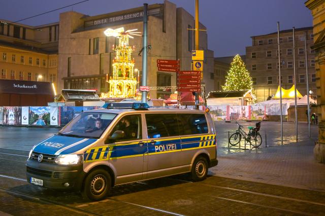 26 December 2024, Saxony-Anhalt, Halle (Saale): A police vehicle stands in front of the Halle winter market "Winterzauber" to block access. The Halle Winter Market has been organized by the City-Gemeinschaft Halle e.V. since 2009. Photo: Heiko Rebsch/dpa