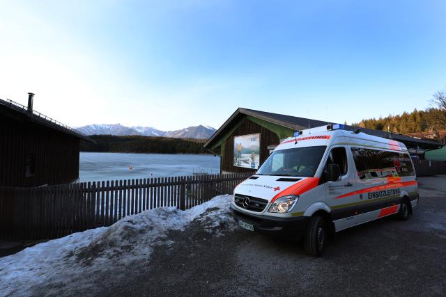 06 March 2025, Bavaria, Grainau: A Red Cross emergency vehicle parks on the shore of Lake Eibsee near the spot where several people break through the ice in the afternoon. Photo: Karl-Josef Hildenbrand/dpa