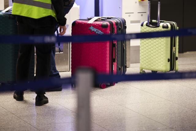 10 March 2025, North Rhine-Westphalia, Duesseldorf: Travelers stand with their suitcases in the departure area at Duesseldorf Airport. The Verdi union has called for a 24-hour warning strike by public service and ground handling workers at eleven airports on Monday. Photo: Christoph Reichwein/dpa