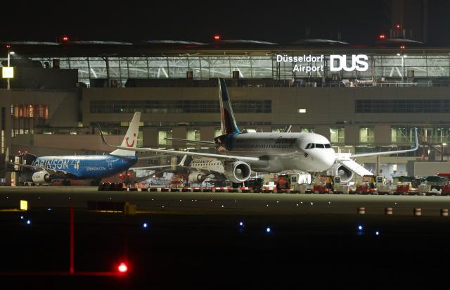 10 March 2025, North Rhine-Westphalia, Duesseldorf: Aircraft park at the terminal building at Duesseldorf Airport in the early morning. The trade union Verdi has called for a 24-hour warning strike by public service and ground handling employees at eleven airports on Monday. Photo: Christoph Reichwein/dpa