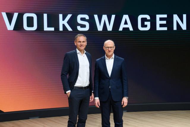 11 March 2025, Lower Saxony, Wolfsburg: Oliver Blume (L), Chairman of the Board of Management of Volkswagen AG and Porsche AG, and Arno Antlitz, Chief Financial Officer of Volkswagen AG, stand in front of a lettering for photographs after the Volkswagen Group's annual press conference in the Autostadt. Photo: Julian Stratenschulte/dpa