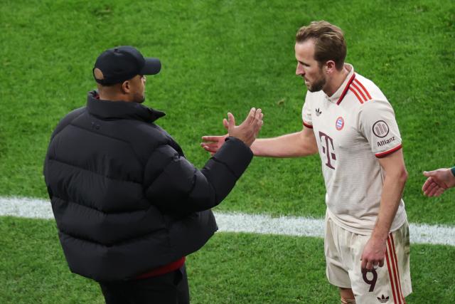 11 March 2025, North Rhine-Westphalia, Leverkusen: Munich coach Vincent Kompany (L) high-fives with Munich's Harry Kane during the UEFA Champions League round of 16 second leg soccer match between Bayer Leverkusen and Bayern Munich at the BayArena. Photo: Rolf Vennenbernd/dpa