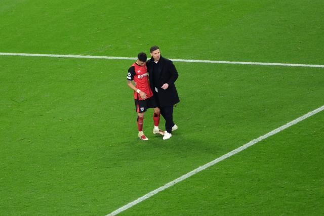 11 March 2025, North Rhine-Westphalia, Leverkusen: Leverkusen coach Xabi Alonso (R) and Leverkusen's Exequiel Palacios walk on the pitch after the UEFA Champions League round of 16 second leg soccer match between Bayer Leverkusen and Bayern Munich at the BayArena. Photo: Rolf Vennenbernd/dpa