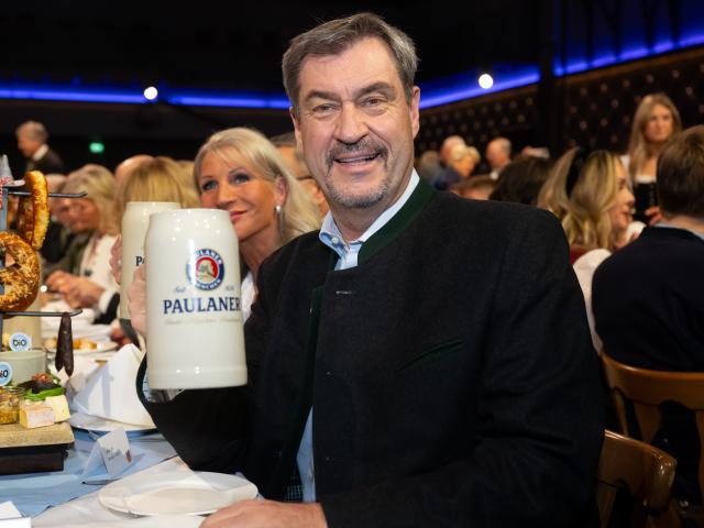 12 March 2025, Bavaria, Munich: Markus Soeder Prime Minister of Bavaria, and his wife Karin Soeder take part in the tapping of the strong beer on the Nockherberg. The strong beer season in Bavaria is traditionally opened with the traditional mocking, the "Derblecken" of politicians at Munich's Nockherberg. Photo: Sven Hoppe/dpa