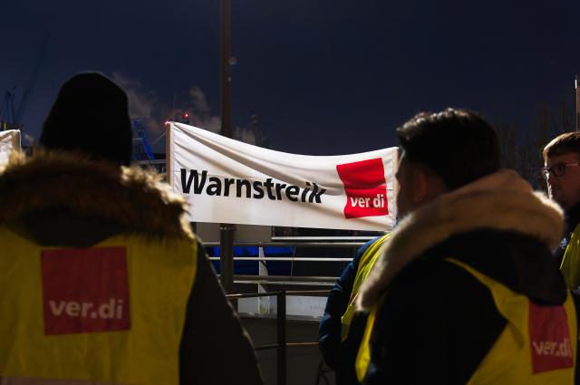 13 March 2025, Hamburg: Participants stand at a picket line in the Port of Hamburg during a Verdi warning strike. Photo: Marcus Golejewski/dpa