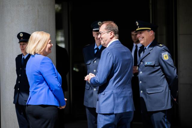 07 May 2025, Berlin: Alexander Dobrindt (R), new German Minister of the Interior and Home Affairs, and Nancy Faeser (L), former Federal Minister of the Interior, speak in front of federal police officers after a photo session marking the handover of official duties at the protocol entrance to the Federal Ministry of the Interior. Photo: Christoph Soeder/dpa