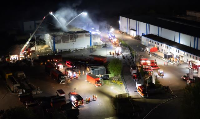 09 May 2025, Lower Saxony, Melbeck: Firefighters extinguish a warehouse on the premises of a recycling company. Photo: Philipp Schulze/dpa