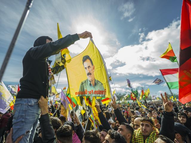 FILED - 25 March 2023, Frankfurt/Main: A person waves a flag bearing the picture of Imprisoned Kurdistan Workers' Party (PKK) leader Abdullah Oecalan during a celebration marking the Kurdish New Year "Newroz" in Frankfurt. Photo: Andreas Arnold/dpa