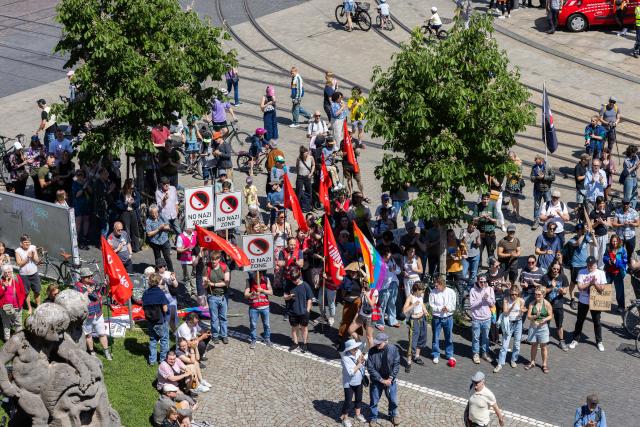 11 May 2025, Baden-Wuerttemberg, Freiburg: Participants in a demonstration stand in front of the Freiburg Theater during a rally as part of the nationwide day of action "No more excuses - ban the AfD now!", called by the alliance "Together against the right". Photo: Philipp von Ditfurth/dpa