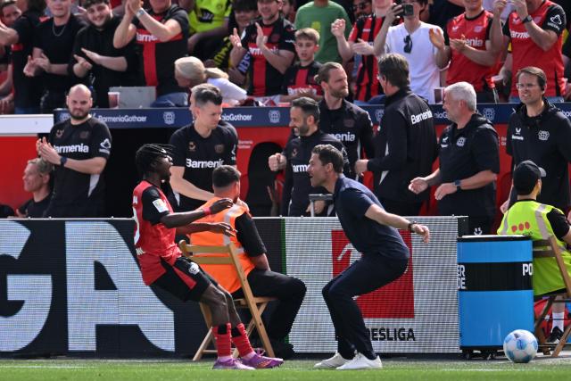 11 May 2025, North Rhine-Westphalia, Leverkusen: Leverkusen's Jeremie Frimpong celebrates scoring his side's first goal with Leverkusen coach Xabi Alonso during the German Bundesliga soccer match between Bayer Leverkusen and Borussia Dortmund at BayArena. Photo: Marius Becker/dpa - IMPORTANT NOTICE: DFL and DFB regulations prohibit any use of photographs as image sequences and/or quasi-video.