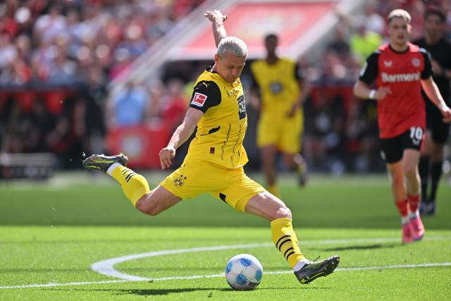 11 May 2025, North Rhine-Westphalia, Leverkusen: Dortmund's Julian Ryerson scores his side's second goal during the German Bundesliga soccer match between Bayer Leverkusen and Borussia Dortmund at BayArena. Photo: Marius Becker/dpa - IMPORTANT NOTICE: DFL and DFB regulations prohibit any use of photographs as image sequences and/or quasi-video.