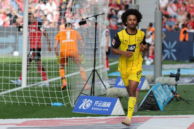 11 May 2025, North Rhine-Westphalia, Leverkusen: Dortmund's Karim Adeyemi celebrates scoring his side's third goal during the German Bundesliga soccer match between Bayer Leverkusen and Borussia Dortmund at BayArena. Photo: Rolf Vennenbernd/dpa - IMPORTANT NOTICE: DFL and DFB regulations prohibit any use of photographs as image sequences and/or quasi-video.