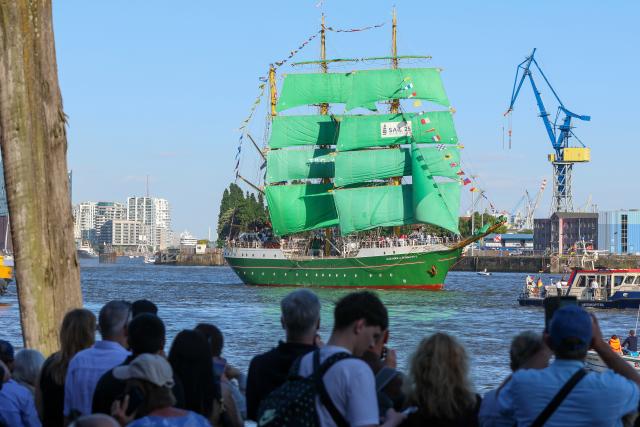 11 May 2025, Hamburg: Spectators at the port watch the departure parade at the end of the 836th Hamburg Port Birthday, including the three-masted barque "Alexander von Humboldt II". Photo: Bodo Marks/dpa