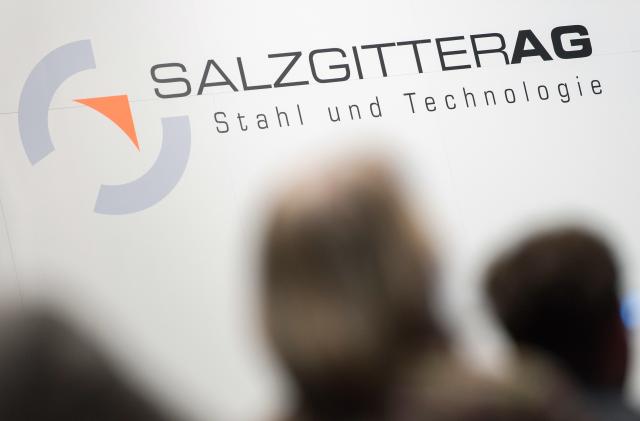 FILED - 01 June 2016, Lower Saxony, Braunschweig: Shareholders sit in front of the Salzgitter AG logo during the Annual General Meeting of Salzgitter AG. German steelmaker Salzgitter slipped into the red in the first quarter, reporting a loss on Monday as weak prices and lower trading volumes weighed on sales. Photo: Sebastian Gollnow/dpa