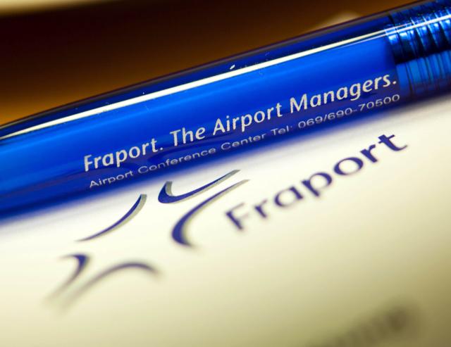 FILED - 11 March 2011, Frankfurt_Main: A ballpoint pen with the Fraport AG logo lies on a table during the airport operator's annual press conference in Frankfurt am Main. German airport operator Fraport Group on Tuesday reported a loss in the first quarter of 2025. Photo: Frank Rumpenhorst/dpa