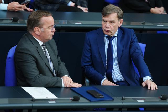 14 May 2025, Berlin: German Defence Minister Boris Pistorius (L), speaks with Foreign Minister Johann Wadephul, during the plenary of the German Bundestag during the government questioning. Photo: Michael Kappeler/dpa