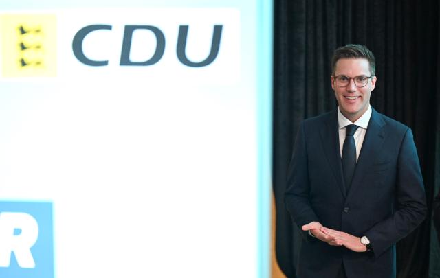 17 May 2025, Baden-Württemberg, Stuttgart: Manuel Hagel, state chairman of the hristian Democratic Union of Germany (CDU) Baden-Wuerttemberg, stands next to a party logo before the CDU state party conference begins. Photo: Bernd Weißbrod/dpa