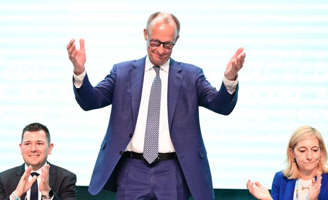 17 May 2025, Baden-Württemberg, Stuttgart: German Chancellor Friedrich Merz waves to the delegates on the podium at the at the state party conference of the Christian Democratic Union of Germany (CDU) Baden-Wuerttemberg. Photo: Bernd Weißbrod/dpa