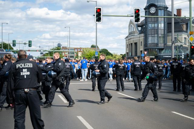 24 May 2025, Berlin: Bielefeld fans march from Heerstrasse to the Olympic Stadium, ahead of the German DFB Cup final soccer match against Stuttgart. Photo: Christophe Gateau/dpa