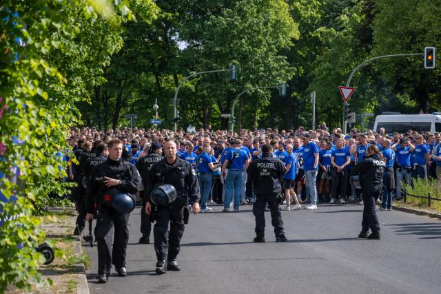 24 May 2025, Berlin: Bielefeld fans march from Heerstrasse to the Olympic Stadium, ahead of the German DFB Cup final soccer match against Stuttgart. Photo: Christophe Gateau/dpa