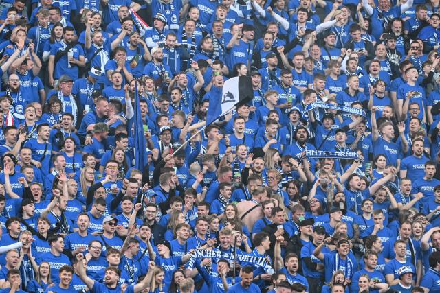 24 May 2025, Berlin: Bielefeld fans cheer in the stands before the start of the German DFB Cup final soccer match between Arminia Bielefeld and VfB Stuttgart at the Olympiastadion. Photo: Federico Gambarini/dpa
