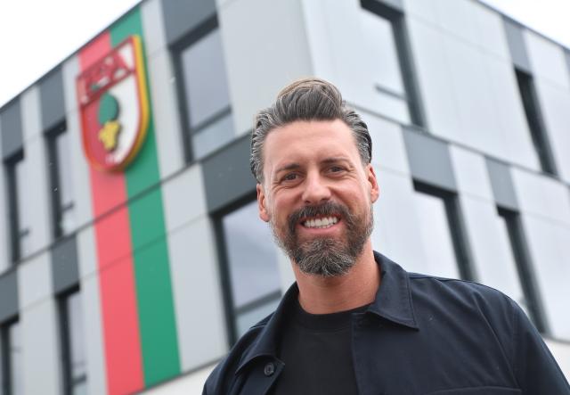 28 May 2025, Bavaria, Augsburg: Sandro Wagner, new coach of FC Augsburg, stands in front of the WWK Arena. Photo: Karl-Josef Hildenbrand/dpa - IMPORTANT NOTICE: DFL and DFB regulations prohibit any use of photographs as image sequences and/or quasi-video.