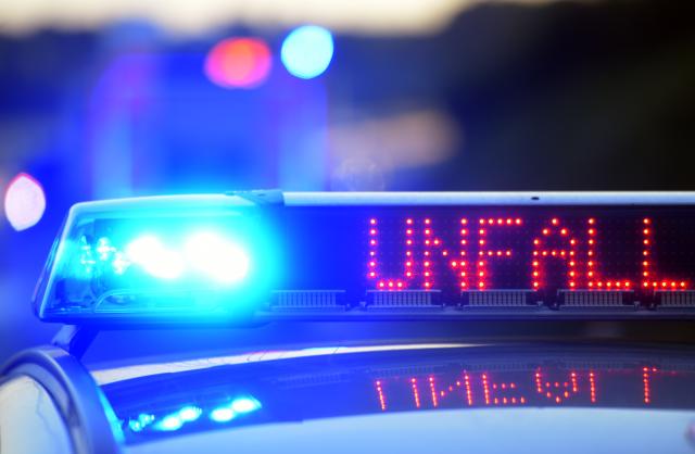 FILED - 11 June 2017, Bavaria, Guenzburg: An illuminated sign on a police vehicle warns of an accident on the A8 freeway. At least 14 people were injured when a car ploughed into a German motorway tailback at high speed, slamming into five other cars in succession, police reported on Sunday. Photo: Stefan Puchner/dpa