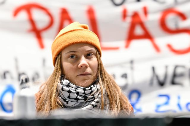 FILED - 06 December 2024, Baden-Württemberg, Mannheim: Swedish Activist Greta Thunberg sits on the podium at a pro-Palestine demonstration in Mannheim. Activists intend to bring aid supplies to the Gaza Strip using a sailing ship, with Swedish activist Greta Thunberg on board. Photo: Uwe Anspach/dpa