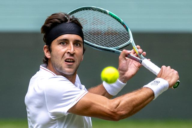 19 June 2025, North Rhine-Westphalia, Halle (westfalen): Argentine tennis player Tomas Martin Etcheverry in action against Russia's Andrey Rublev during their men's singles round of 16 match at the Terra Wortmann Open. Photo: David Inderlied/dpa